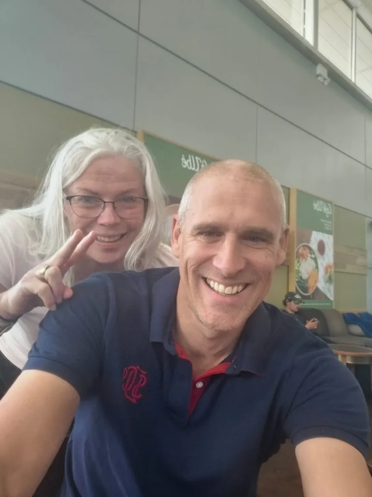 Jo Norman and her coach Tim at the airport before the swim